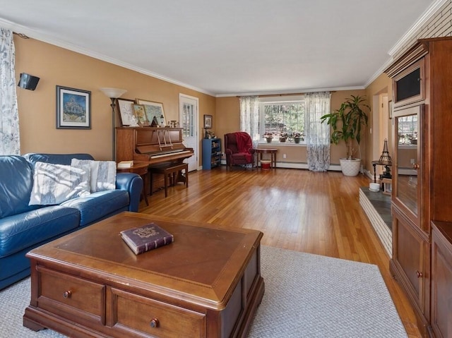 living room with light wood-style floors, ornamental molding, and baseboards