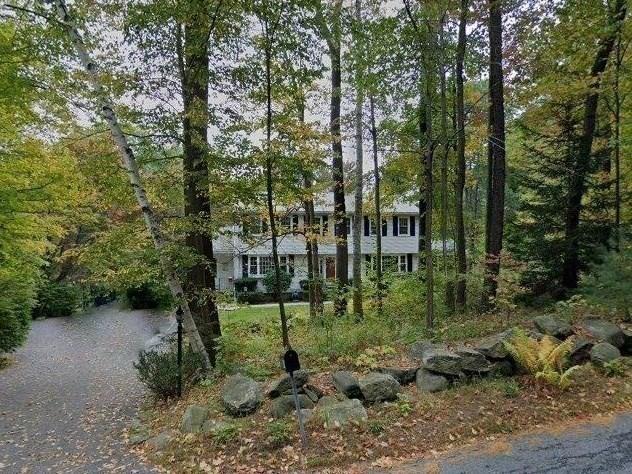 view of front of house featuring a forest view