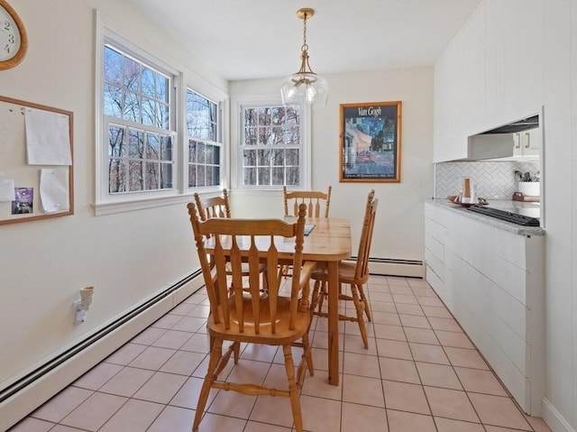 dining space featuring light tile patterned floors and a baseboard heating unit