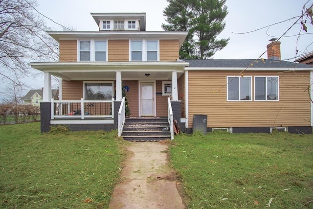 view of front of house with a front yard and a porch