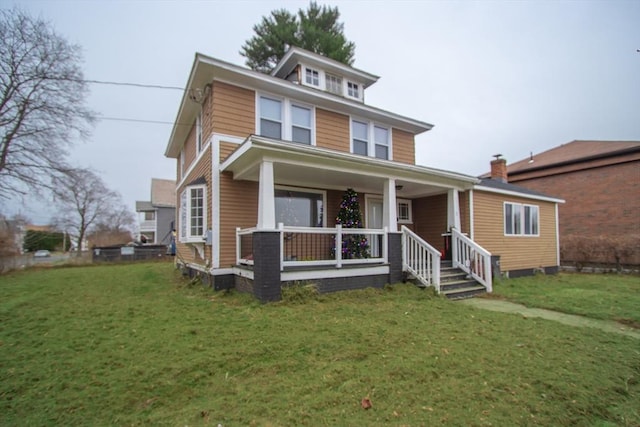 view of front of house with a front yard and a porch