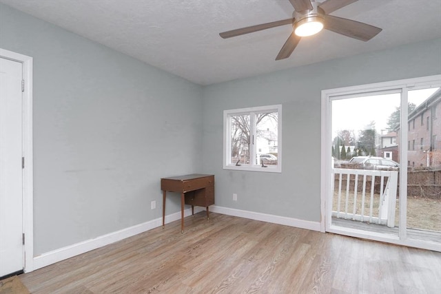 empty room featuring light wood-type flooring and ceiling fan