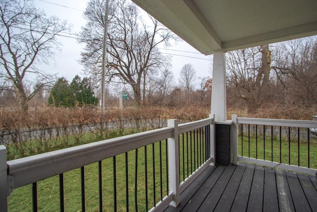 wooden terrace with a lawn