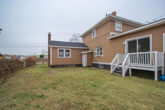 rear view of house featuring a yard