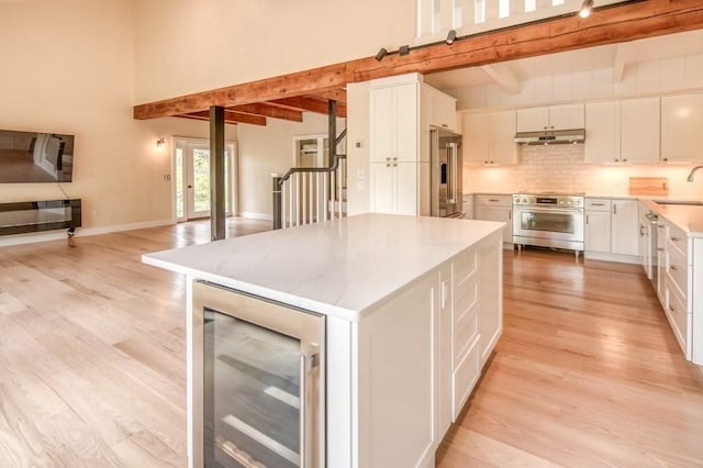 212 Charles Neck Way, West Tisbury, MA 02575 - kitchen featuring high end appliances, beverage cooler, under cabinet range hood, and light wood-type flooring