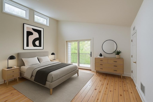 212 Charles Neck Way, West Tisbury, MA 02575 - bedroom featuring access to exterior, multiple windows, light wood-style floors, and baseboards