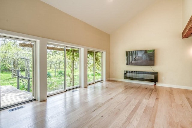 212 Charles Neck Way, West Tisbury, MA 02575 - unfurnished living room featuring high vaulted ceiling, light wood finished floors, and baseboards