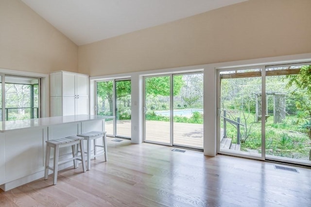 212 Charles Neck Way, West Tisbury, MA 02575 - dining room featuring light wood-type flooring and lofted ceiling