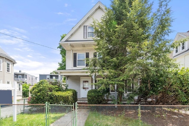 view of front of house with a fenced front yard and a porch