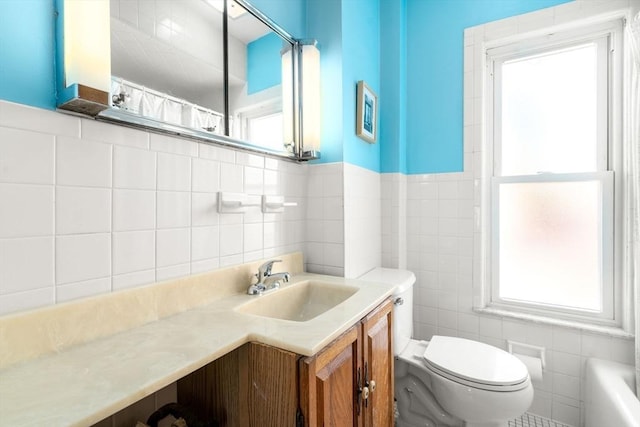 full bath with tile walls, toilet, vanity, and a shower with curtain