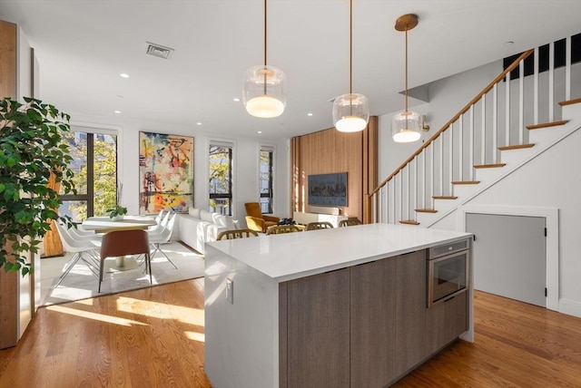 kitchen with pendant lighting, a center island, and light hardwood / wood-style floors