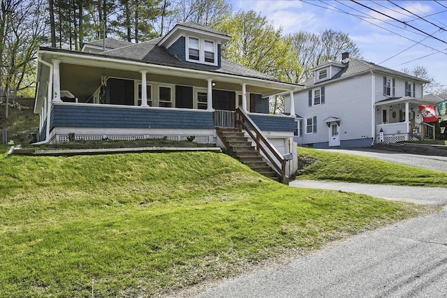 28 Upton St, Adams, MA 01220 - view of front of home with covered porch, driveway, roof with shingles, and a front lawn