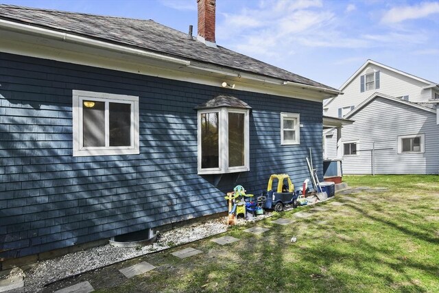 28 Upton St, Adams, MA 01220 - view of side of home with a shingled roof, a chimney, and a lawn
