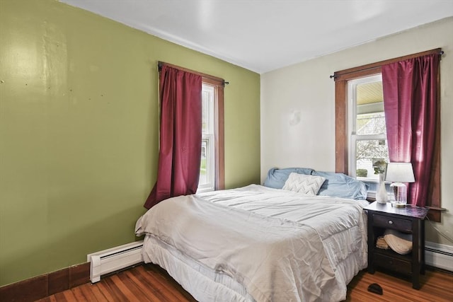 28 Upton St, Adams, MA 01220 - bedroom with baseboards, multiple windows, baseboard heating, and wood finished floors