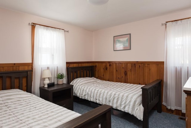 bedroom with a wainscoted wall and wood walls