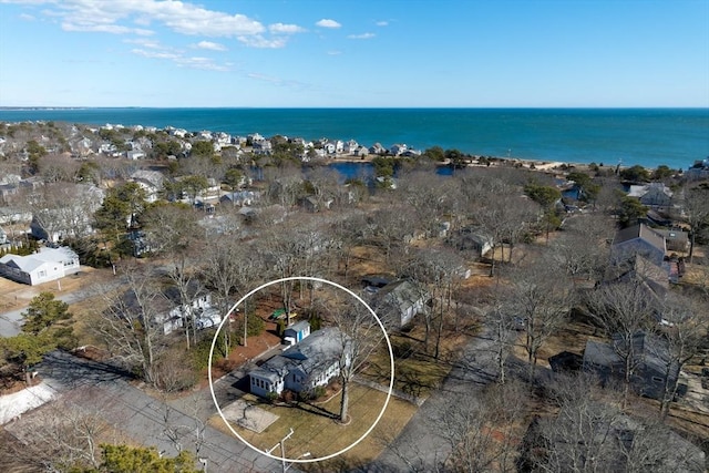 birds eye view of property with a water view and a view of the beach