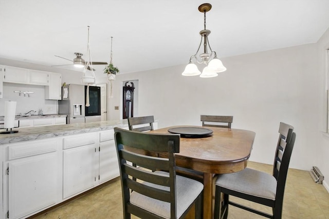 dining room with ceiling fan with notable chandelier