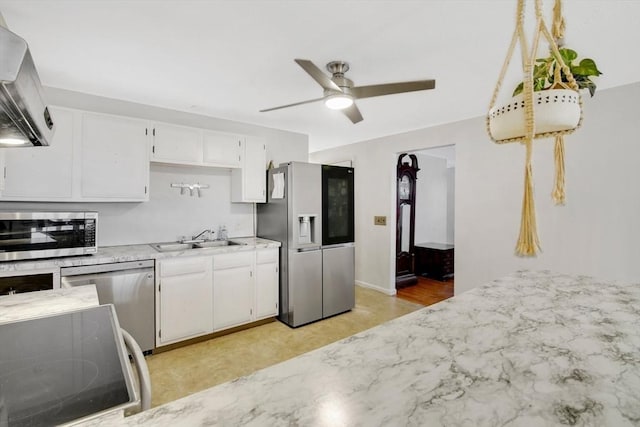 kitchen with white cabinets, ventilation hood, sink, ceiling fan, and appliances with stainless steel finishes