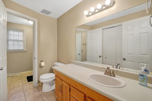 bathroom featuring toilet, vanity, and tile patterned floors