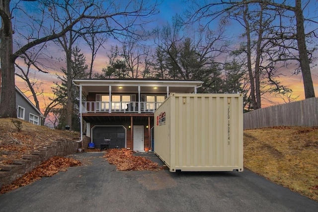 view of front facade with a balcony and a garage