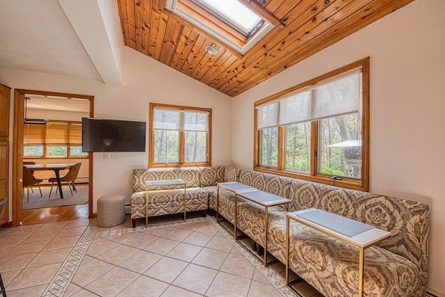sitting room featuring light tile patterned flooring, wooden ceiling, and vaulted ceiling with skylight