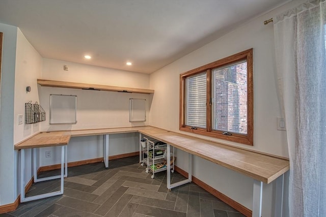 office space with recessed lighting, baseboards, and built in desk