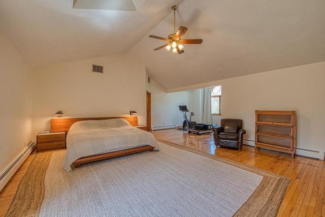 bedroom with visible vents, wood-type flooring, lofted ceiling, and a baseboard heating unit
