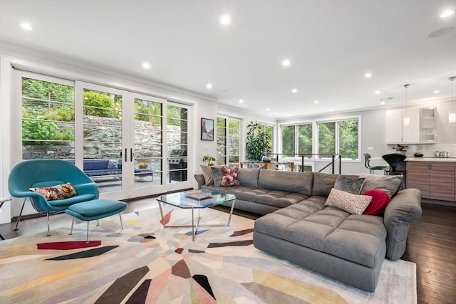 living room with french doors, recessed lighting, and crown molding