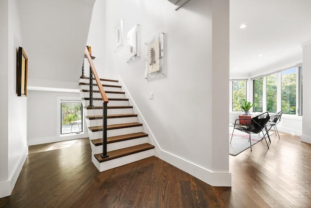 staircase featuring recessed lighting, baseboards, and wood finished floors