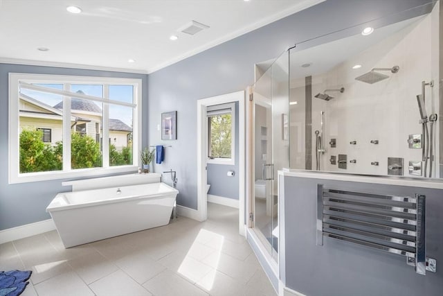 full bathroom with ornamental molding, a soaking tub, a shower stall, and tile patterned floors