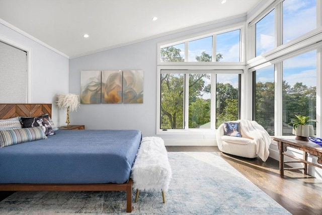 bedroom with recessed lighting, vaulted ceiling, crown molding, and wood finished floors