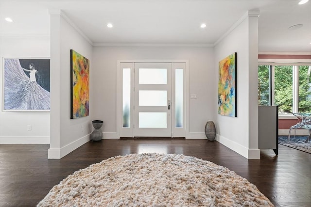 entrance foyer featuring dark wood-style floors, baseboards, and crown molding