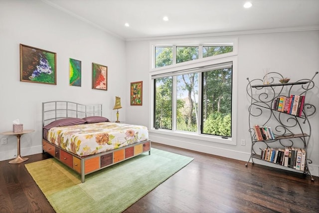 bedroom with multiple windows, dark wood-type flooring, and crown molding