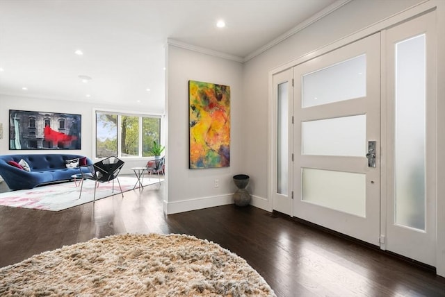 foyer entrance with crown molding, baseboards, dark wood-style flooring, and recessed lighting