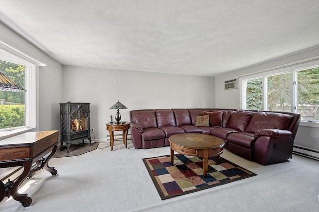 2 Proctor Cir, Peabody, MA 01960 - living area with light colored carpet, healthy amount of natural light, a wood stove, and a wall mounted AC