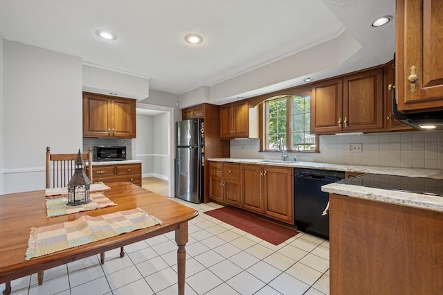 2 Proctor Cir, Peabody, MA 01960 - kitchen featuring black appliances, brown cabinetry, backsplash, recessed lighting, and light stone countertops