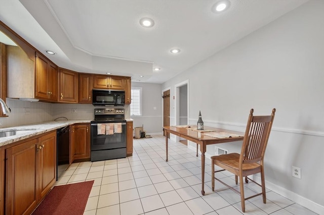 2 Proctor Cir, Peabody, MA 01960 - kitchen with black appliances, backsplash, brown cabinets, recessed lighting, and light stone counters