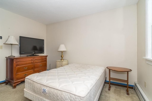 bedroom featuring a baseboard heating unit and light colored carpet