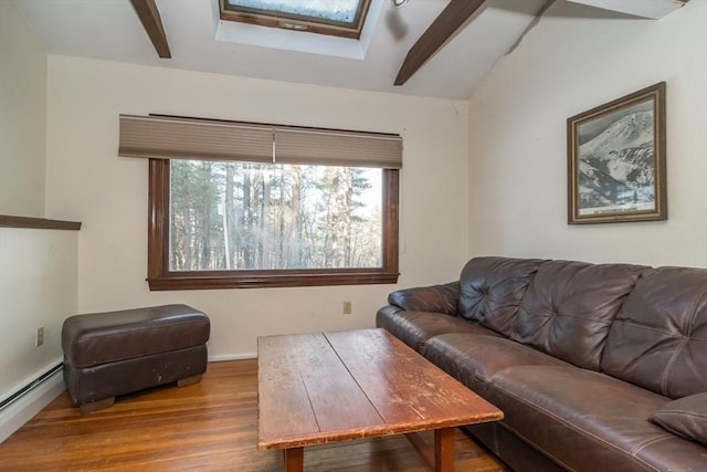 living room featuring a baseboard radiator, wood-type flooring, and vaulted ceiling with skylight