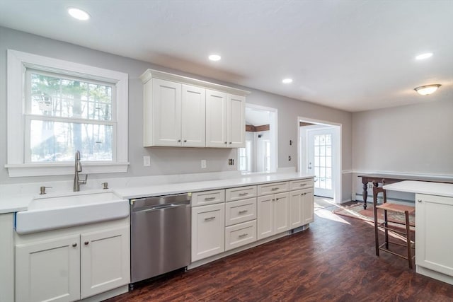 kitchen featuring white cabinetry, dark hardwood / wood-style flooring, dishwasher, and sink