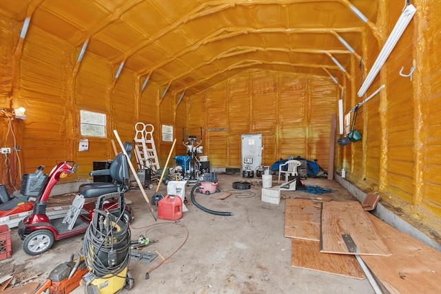 misc room featuring a garage and vaulted ceiling