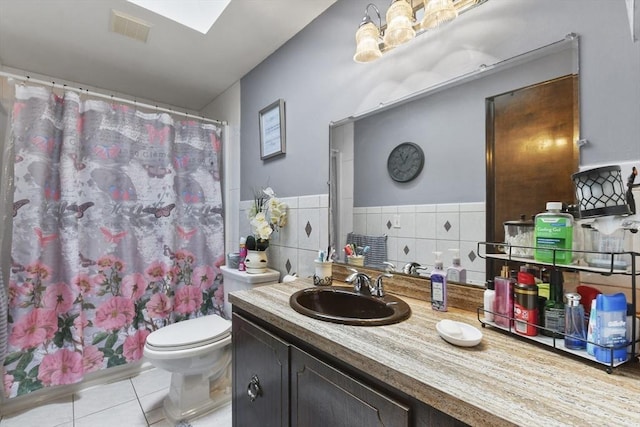 288 Norman St, Fall River, MA 02721 - full bath with tile patterned flooring, toilet, tile walls, vanity, and a shower with curtain
