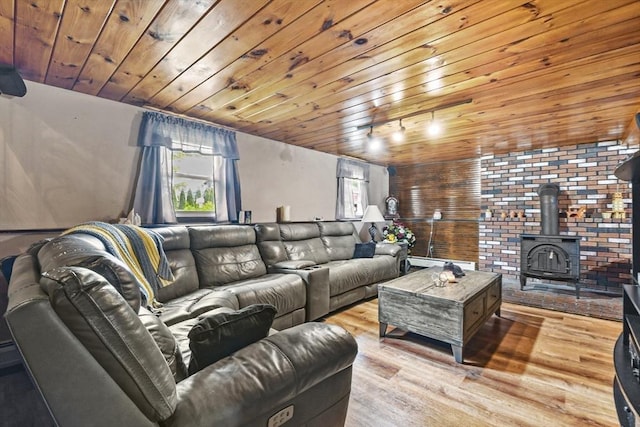 288 Norman St, Fall River, MA 02721 - living area featuring wooden ceiling, light wood-type flooring, a wood stove, and a baseboard heating unit