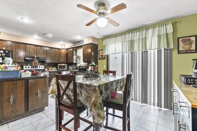 288 Norman St, Fall River, MA 02721 - kitchen with stainless steel stove, light tile patterned floors, extractor fan, and a ceiling fan
