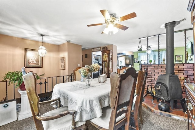 288 Norman St, Fall River, MA 02721 - dining area featuring a wood stove, ceiling fan, and carpet