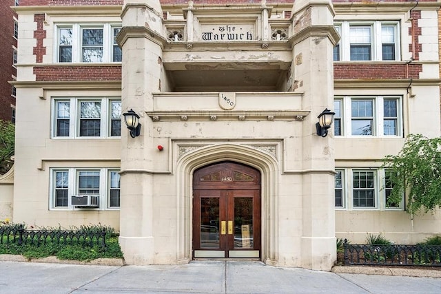 1450-1454 Beacon St Unit 301, Brookline, MA 02446 - view of exterior entry with french doors, cooling unit, stone siding, and brick siding