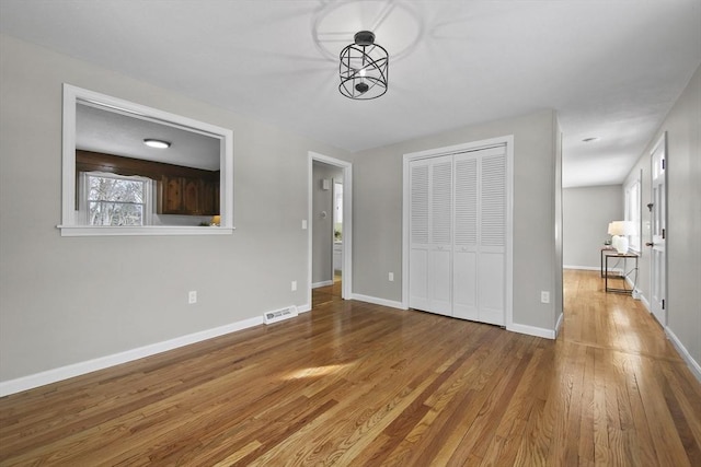 unfurnished bedroom featuring a closet and light wood-type flooring