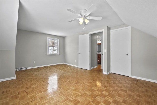 bonus room with ceiling fan, lofted ceiling, and light parquet flooring