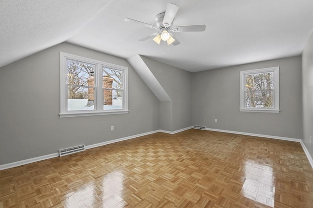 additional living space with light parquet floors, vaulted ceiling, and a wealth of natural light