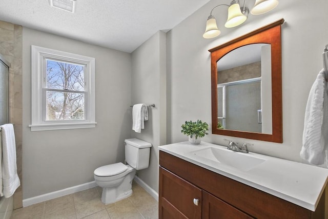 bathroom featuring vanity, a shower with shower door, tile patterned floors, and toilet